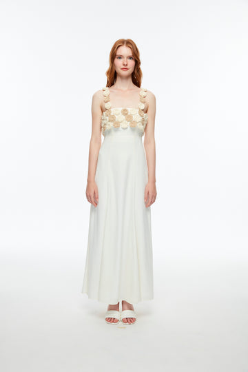 Long white dress decorated with crocheted flowers.